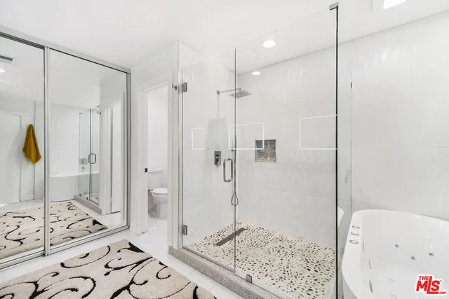 a bathroom with a shower and a sink