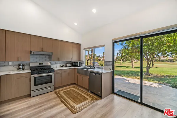 a kitchen with a stove a sink and a microwave