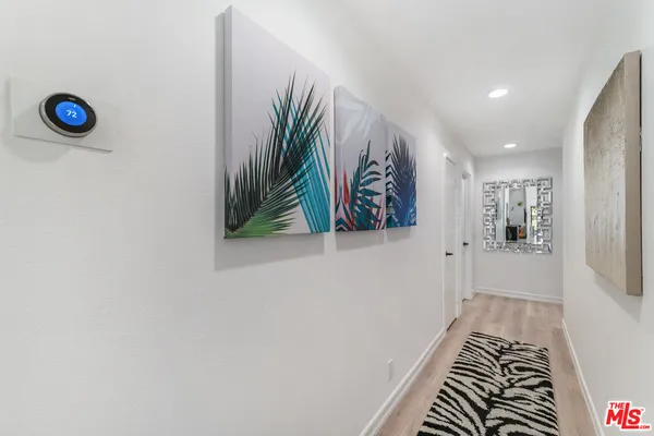 a view of entryway with paintings on the wall