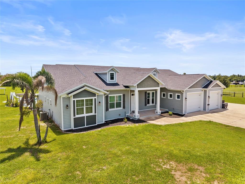 15710 Colding Loop Wimauma, FL 33598 - Photo 37 of 41 a view of a house with a big yard and large trees