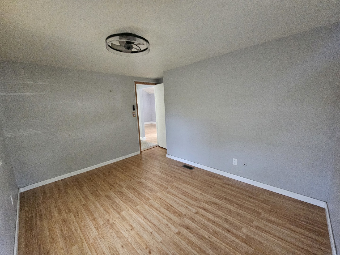 10N827 Hawthorne Street Elgin, IL 60123 - Photo 11 of 14 a view of an empty room with wooden floor and a window