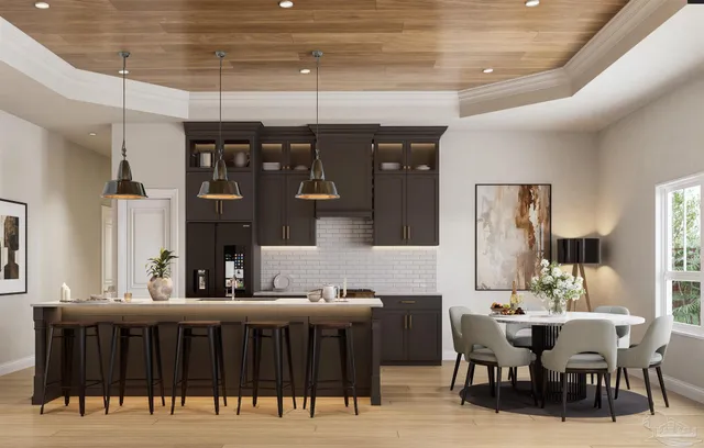 a dining hall with stainless steel appliances kitchen island granite countertop a dining table and chairs