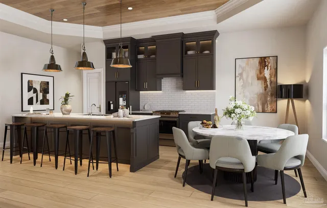 a kitchen with a table chairs refrigerator and microwave