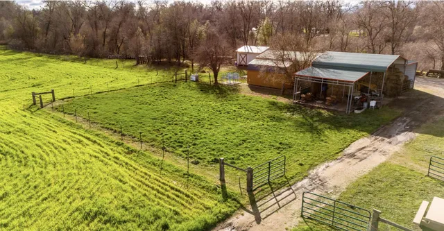 a backyard of a house with yard and outdoor seating
