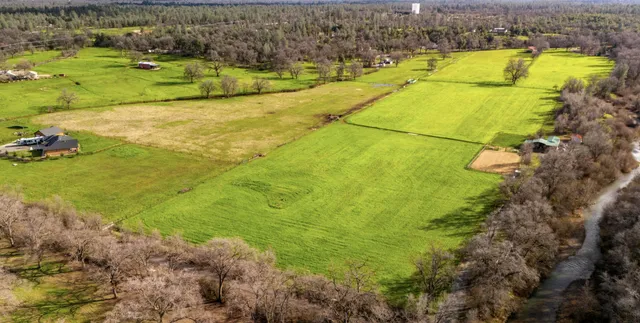 a view of a swimming pool with a yard and sitting area