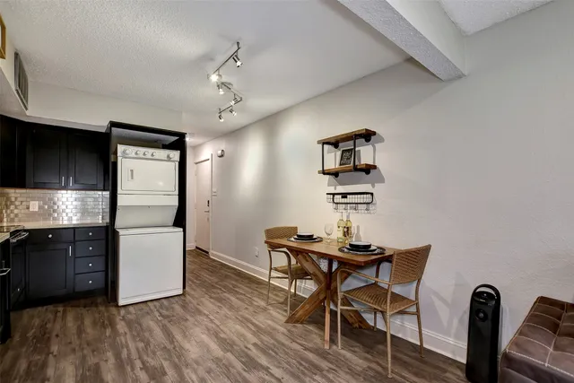 a kitchen with a refrigerator and a stove top oven