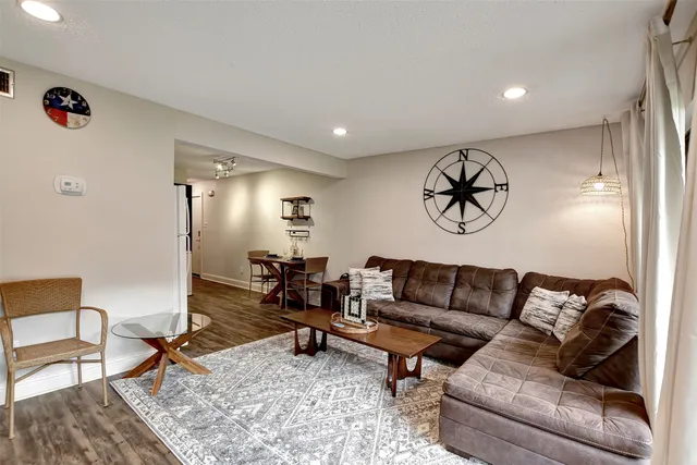 a living room with furniture and a rug