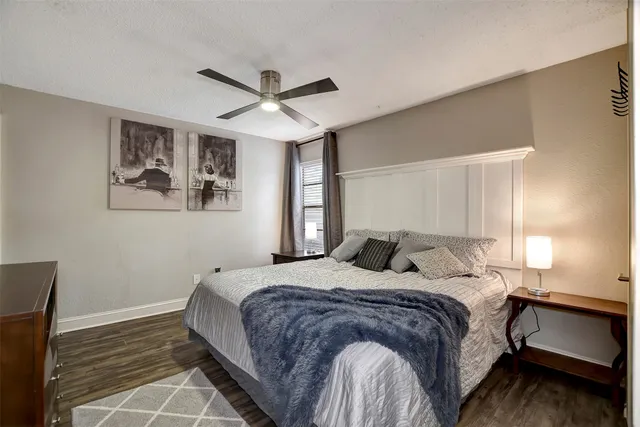 a bedroom with a large bed and a window