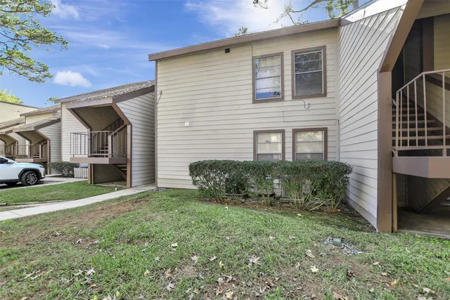 a view of a house with a yard and garage