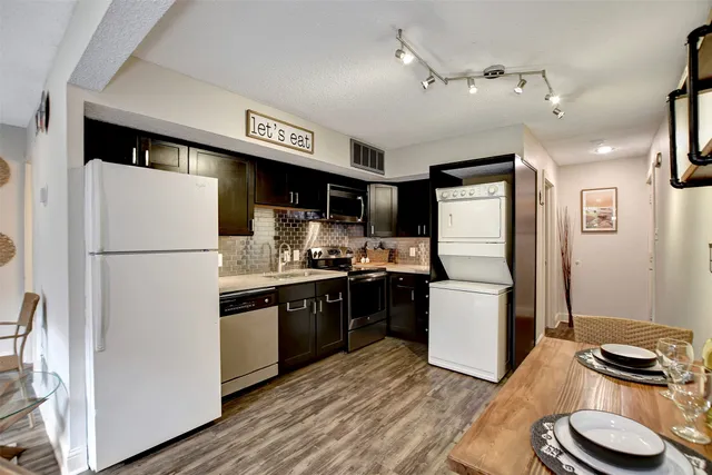 a kitchen with a refrigerator and a stove