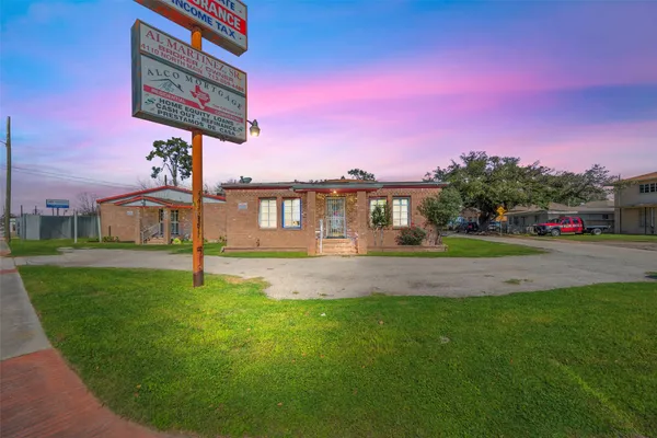 a front view of a house with a yard and street view