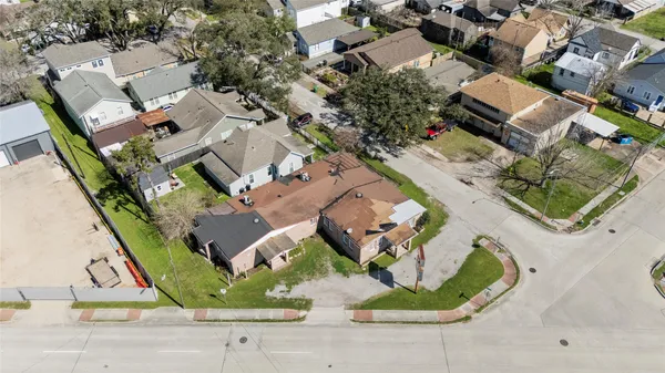 an aerial view of a house with garden space and parking