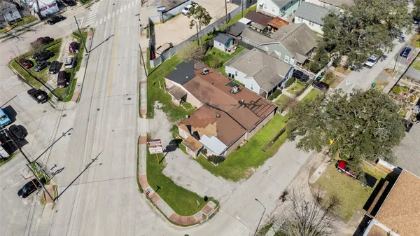 an aerial view of a house with a garden and trees