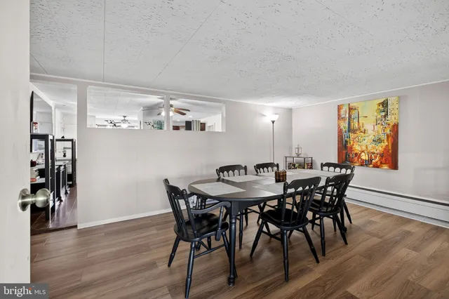 a view of a dining room with furniture and wooden floor