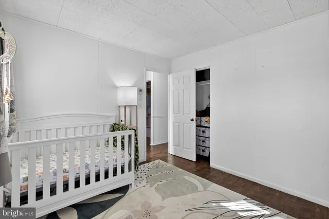 a bedroom with furniture and baby crib