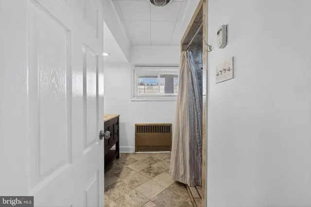 a view of a hallway with closet and furniture