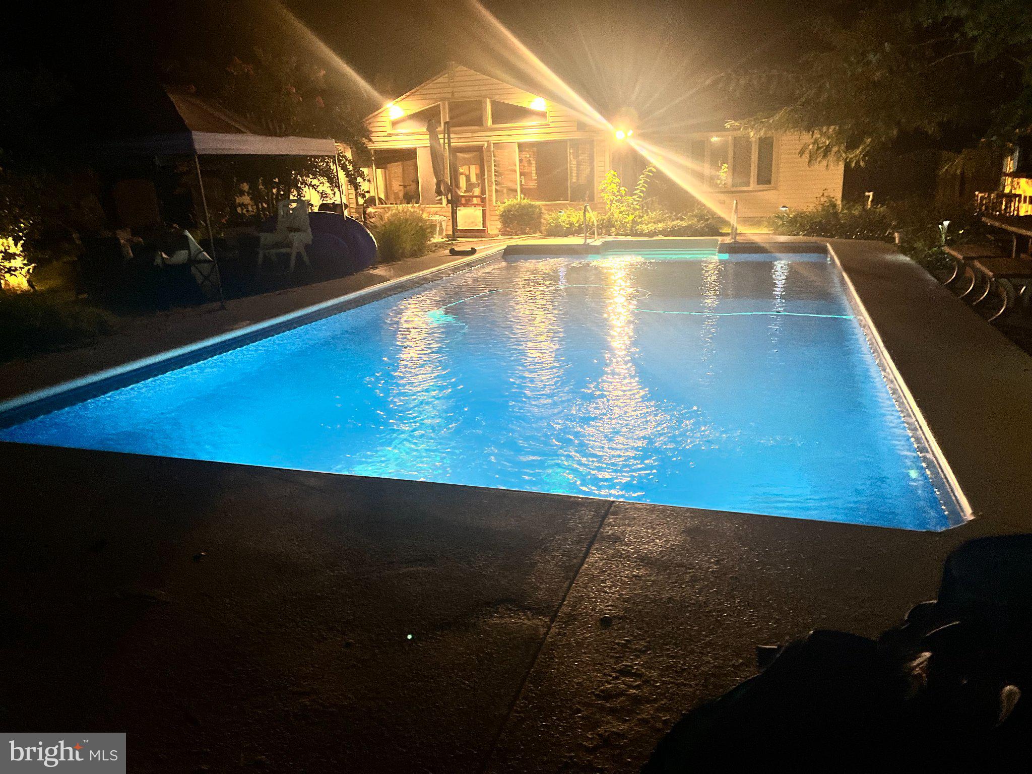 342 Wicomico Road Stevensville, MD 21666 - Photo 10 of 61 Serene night by the illuminated pool.