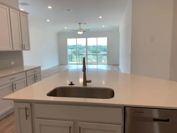 a kitchen with a sink and large window