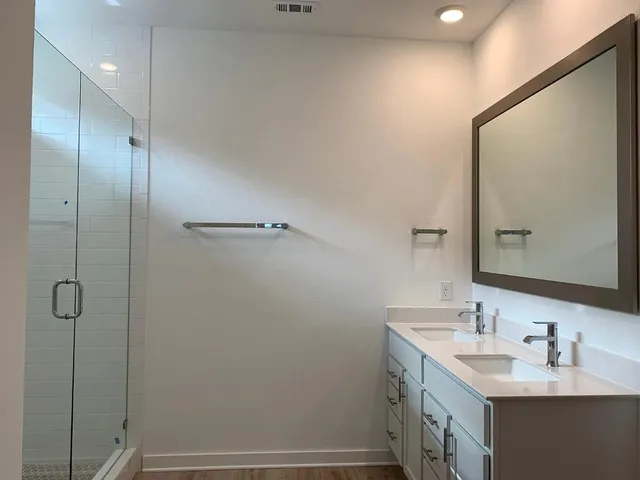 a bathroom with a double vanity sink a and mirror