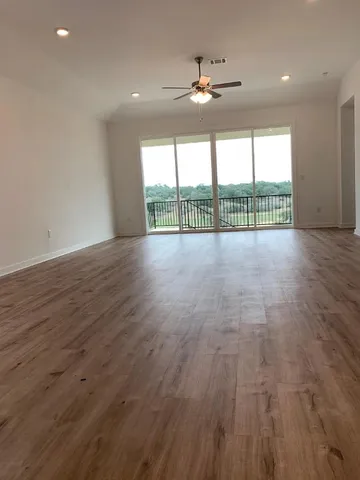 a view of an entryway with wooden floor