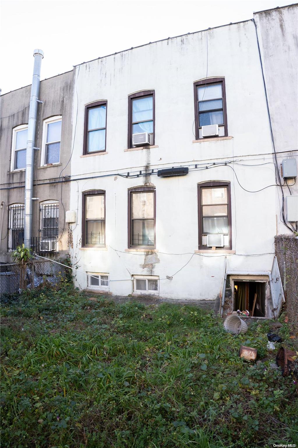 40-61 Junction Boulevard Queens, NY 11368 - Photo 11 of 13 a front view of a house with a yard