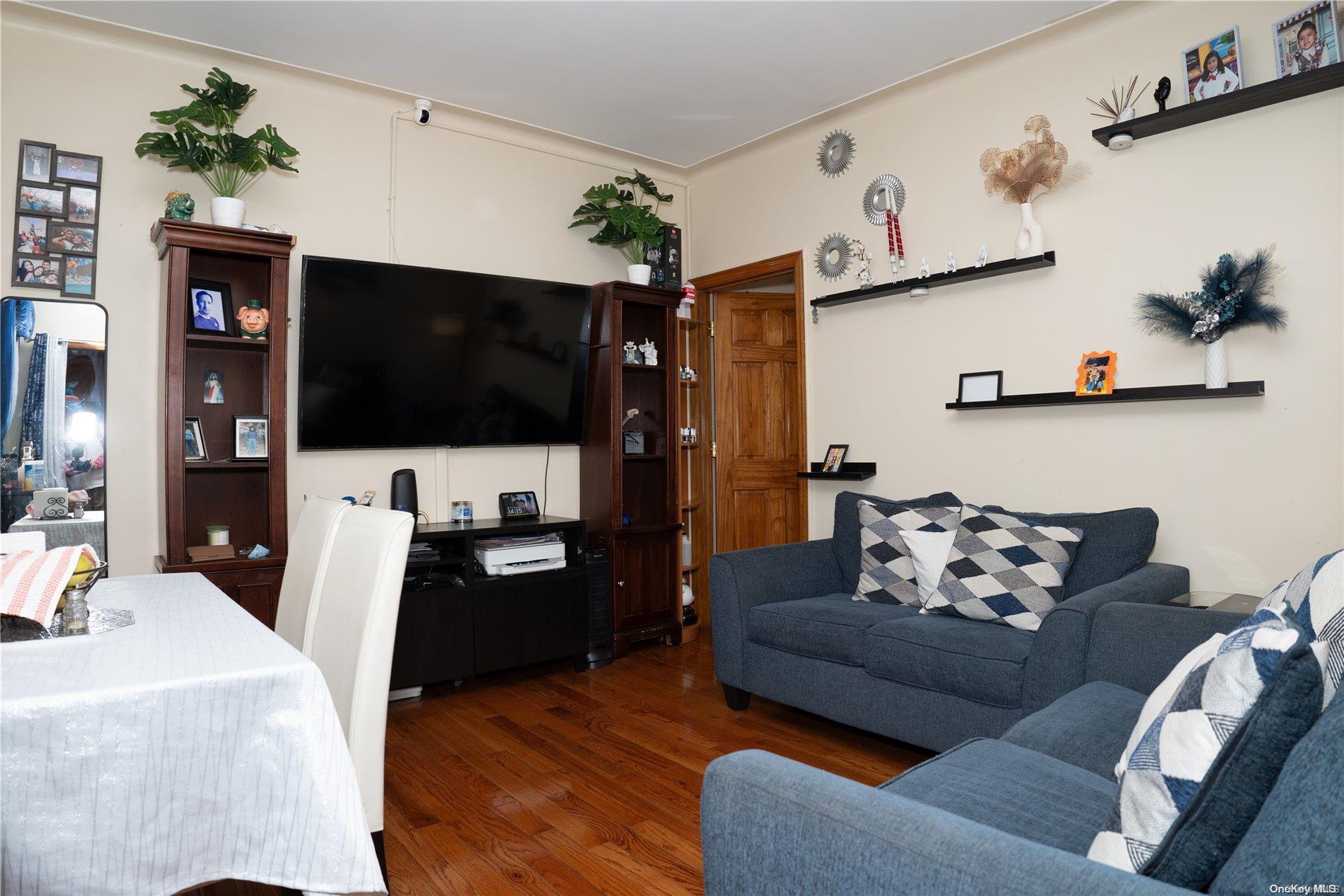 40-61 Junction Boulevard Queens, NY 11368 - Photo 3 of 13 a living room with furniture and a flat screen tv