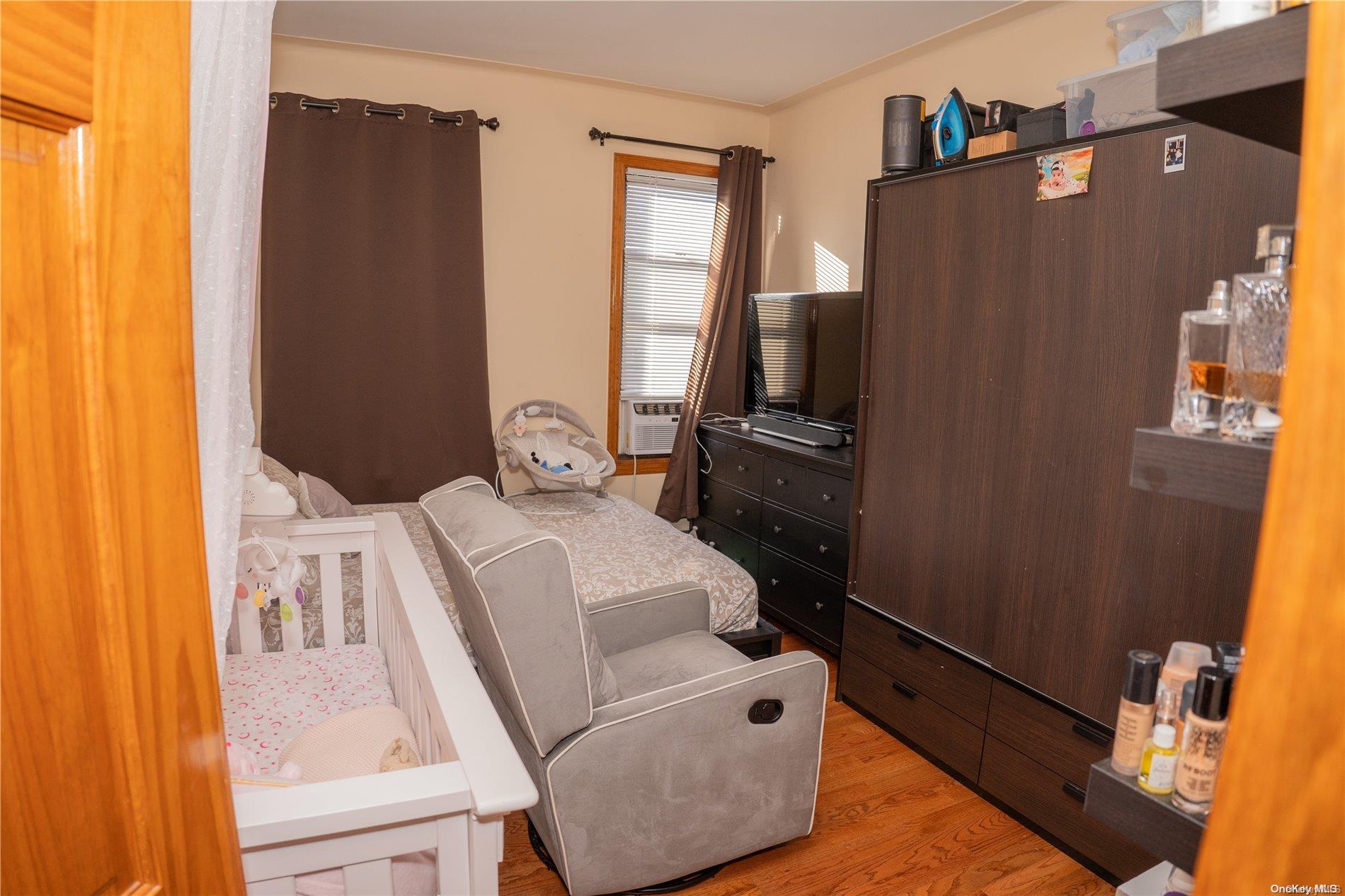 40-61 Junction Boulevard Queens, NY 11368 - Photo 5 of 13 a living room with furniture and a flat screen tv