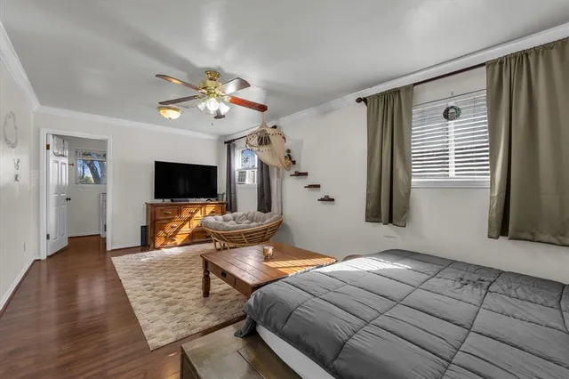 a bedroom with furniture and a flat screen tv