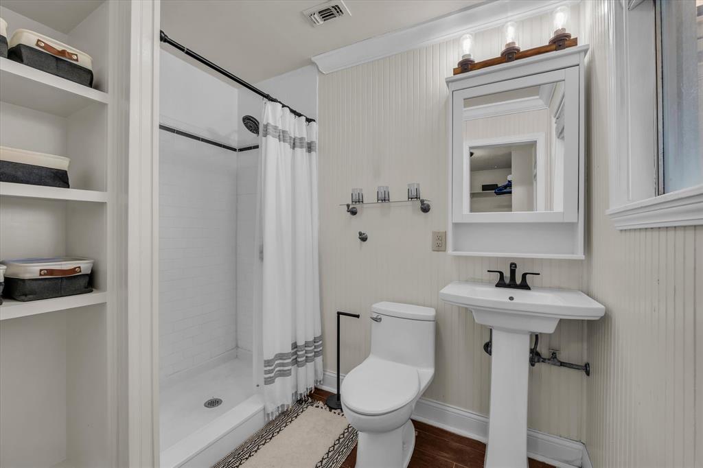 1007 North 57th Street Waco, TX 76710 - Photo 22 of 38 a bathroom with a sink mirror toilet and shower