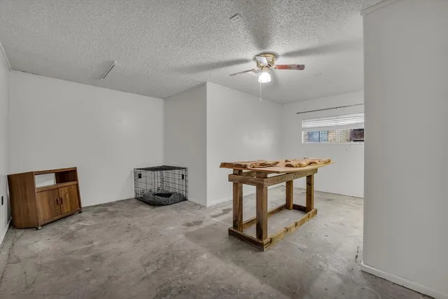a room with furniture and a chandelier fan