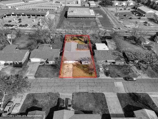 an aerial view of a house with a yard