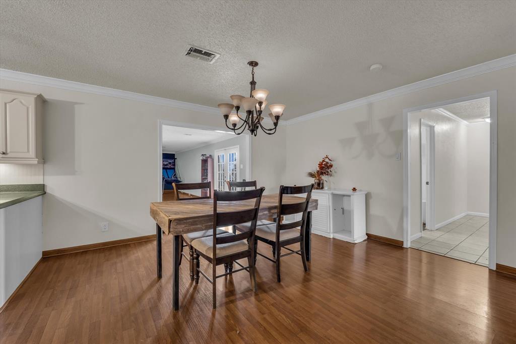 1007 North 57th Street Waco, TX 76710 - Photo 6 of 38 a view of a dining room with furniture and wooden floor
