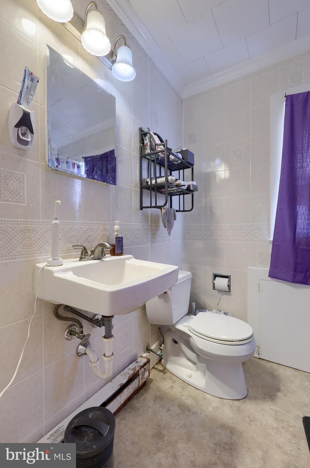 38 Montello Road Reading, PA 19608 - Photo 15 of 25 a bathroom with a sink a toilet a mirror and shower