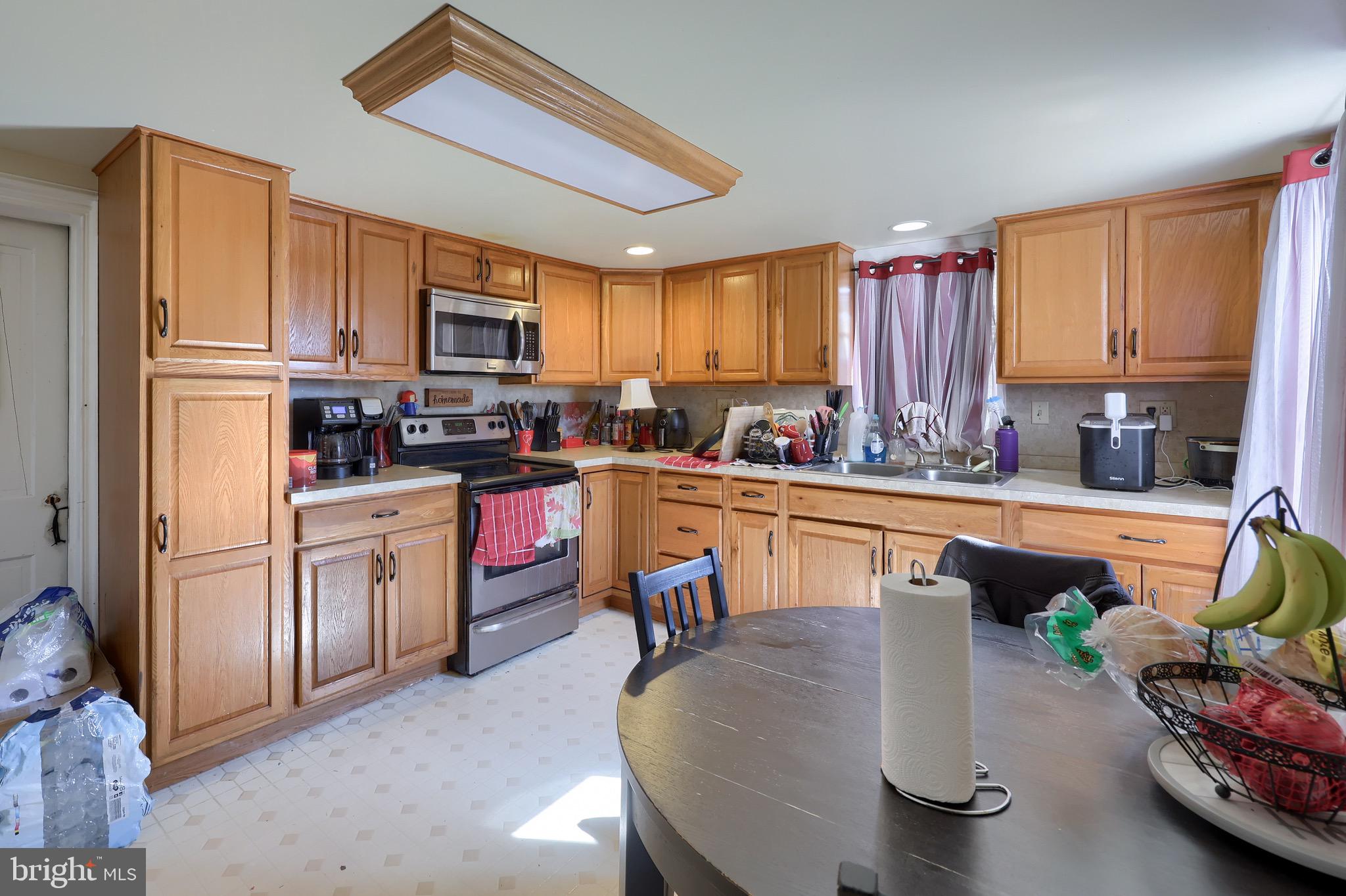 38 Montello Road Reading, PA 19608 - Photo 16 of 25 a kitchen with refrigerator a sink and chairs