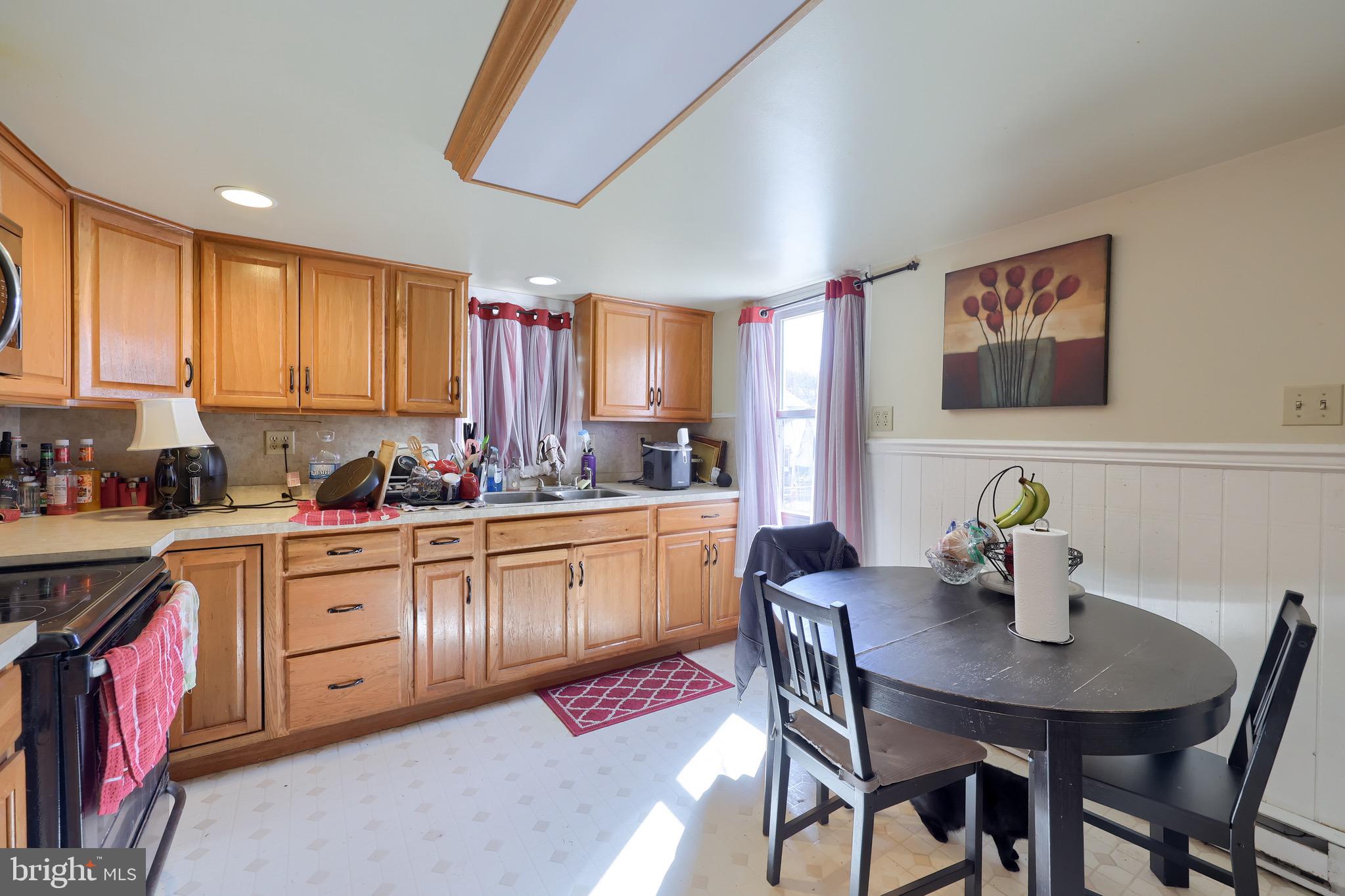 38 Montello Road Reading, PA 19608 - Photo 17 of 25 a kitchen with stainless steel appliances a dining table chairs and window