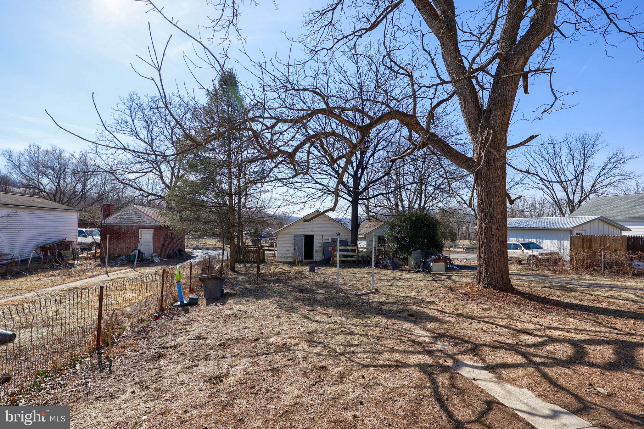 38 Montello Road Reading, PA 19608 - Photo 23 of 25 a backyard of a house with wooden fence and large trees