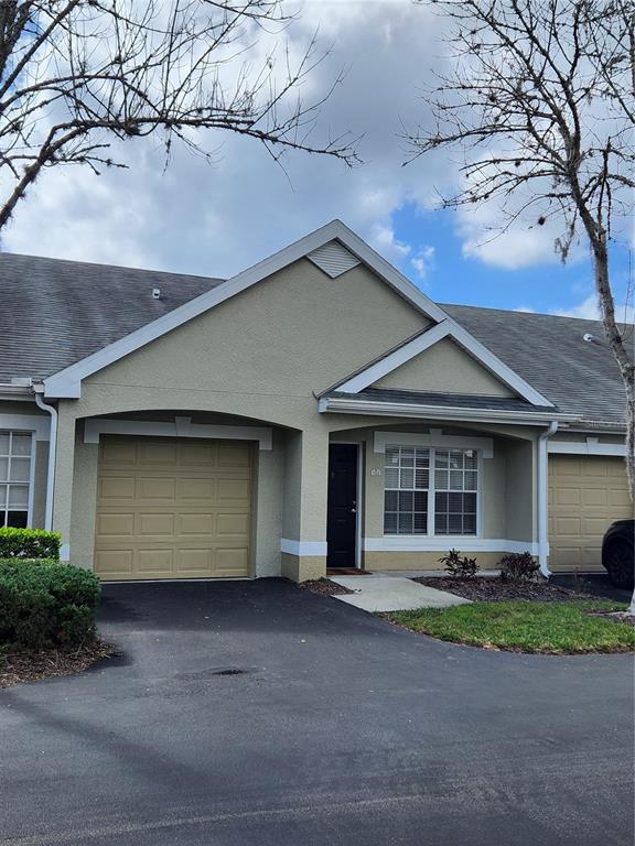 a front view of a house with a garden and plants
