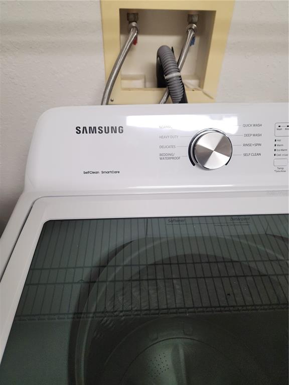 3648 Kings Road, Unit 103 Palm Harbor, FL 34685 - Photo 14 of 26 a utility room with dryer and washer