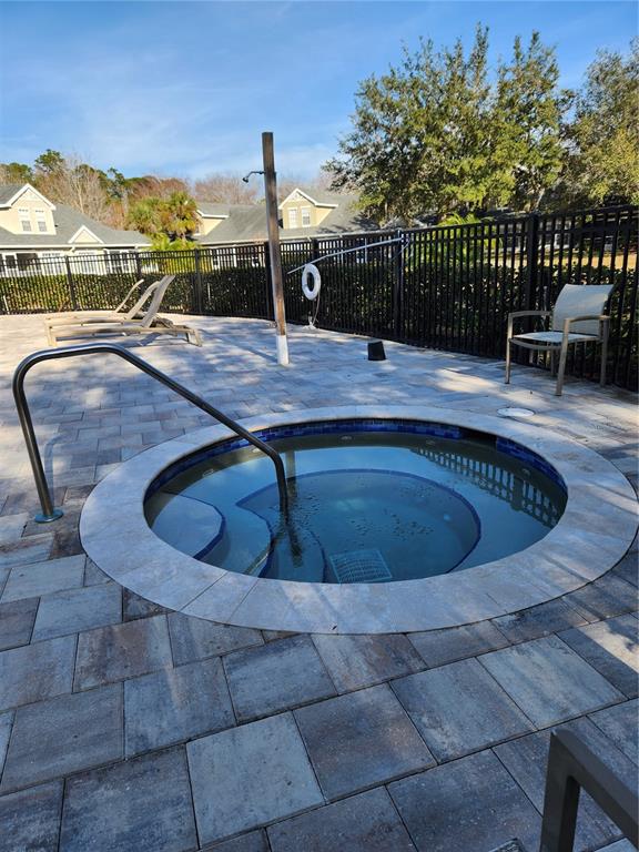 3648 Kings Road, Unit 103 Palm Harbor, FL 34685 - Photo 20 of 26 a view of a swimming pool with a lounge chair