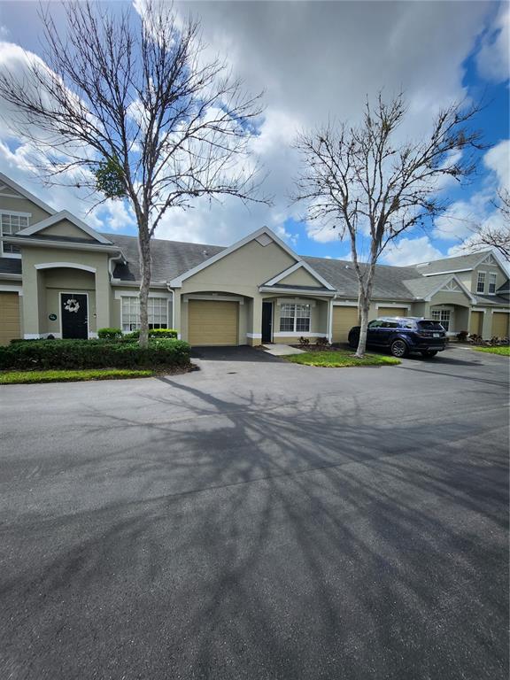 3648 Kings Road, Unit 103 Palm Harbor, FL 34685 - Photo 2 of 26 a front view of a house with a yard