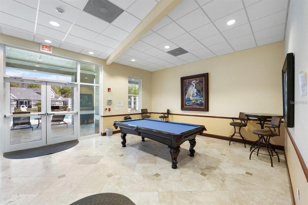 3648 Kings Road, Unit 103 Palm Harbor, FL 34685 - Photo 25 of 26 a living room with furniture pool table and table tennis