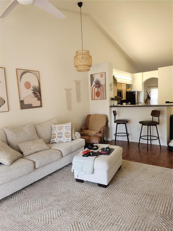 3648 Kings Road, Unit 103 Palm Harbor, FL 34685 - Photo 5 of 26 a living room with furniture a rug and a chandelier