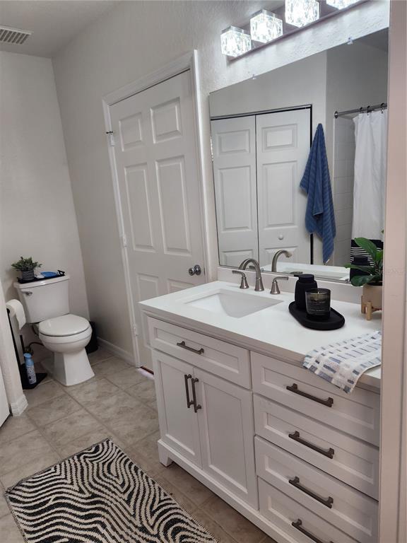 3648 Kings Road, Unit 103 Palm Harbor, FL 34685 - Photo 7 of 26 a bathroom with a double vanity sink and a toilet