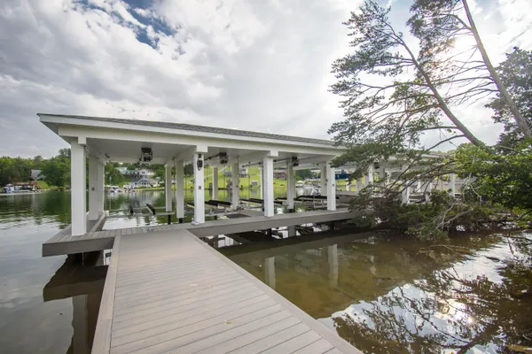 a view of a balcony with chairs and wooden floor