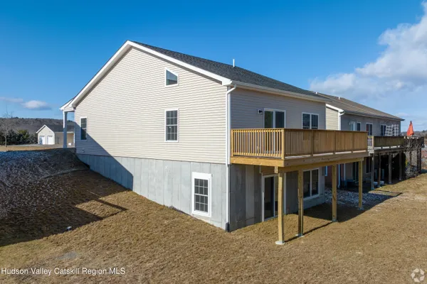 a view of house with deck and entertaining space