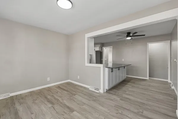 a view of a room with wooden floor