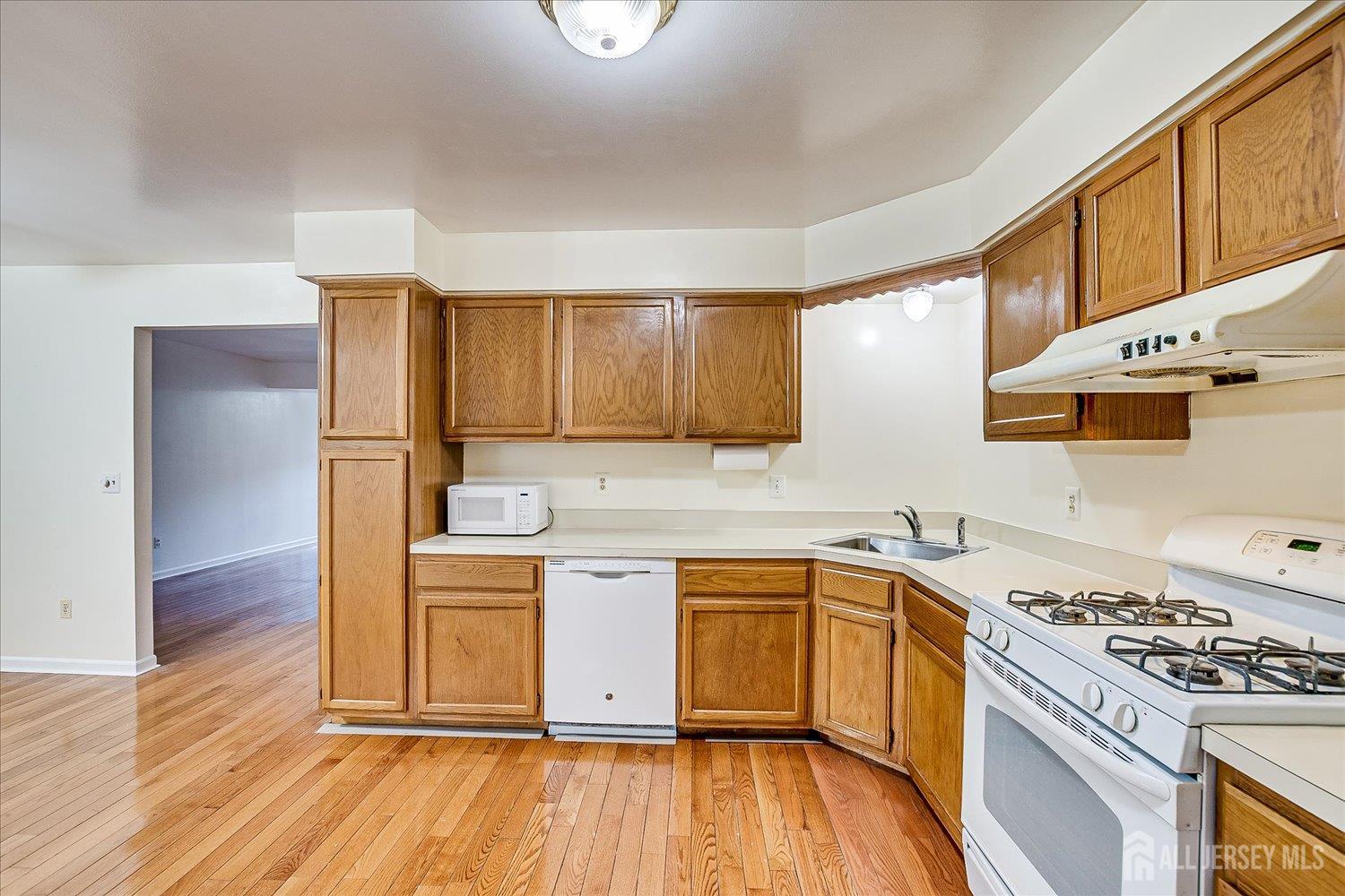 536 Elsie Avenue South Plainfield, NJ 07080 - Photo 11 of 28 a kitchen with a stove a sink and a refrigerator