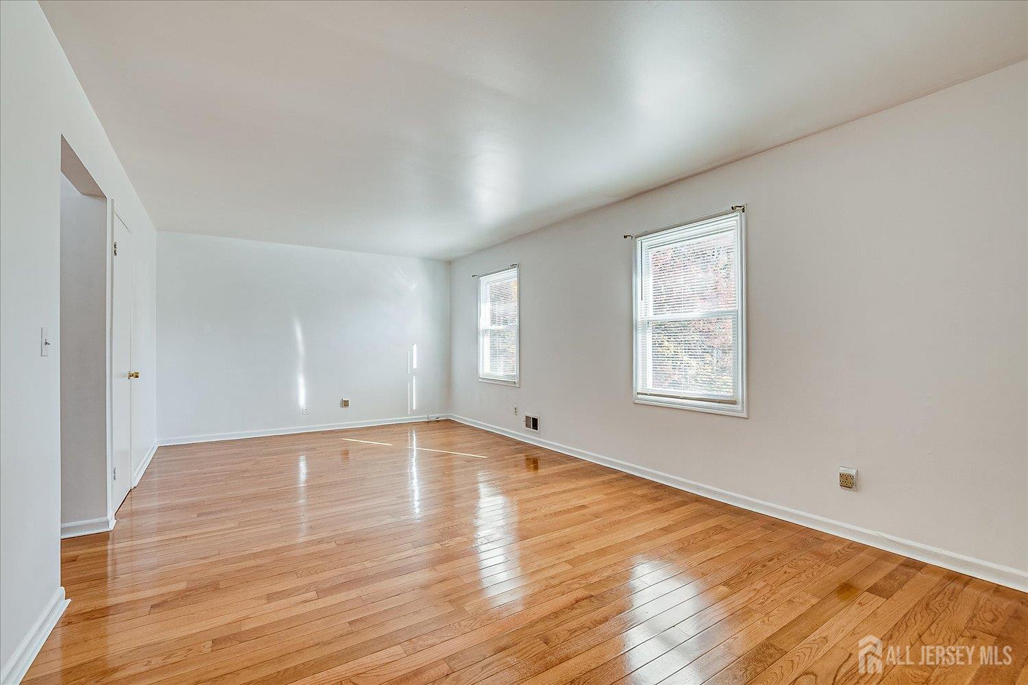 536 Elsie Avenue South Plainfield, NJ 07080 - Photo 17 of 28 an empty room with wooden floor and windows