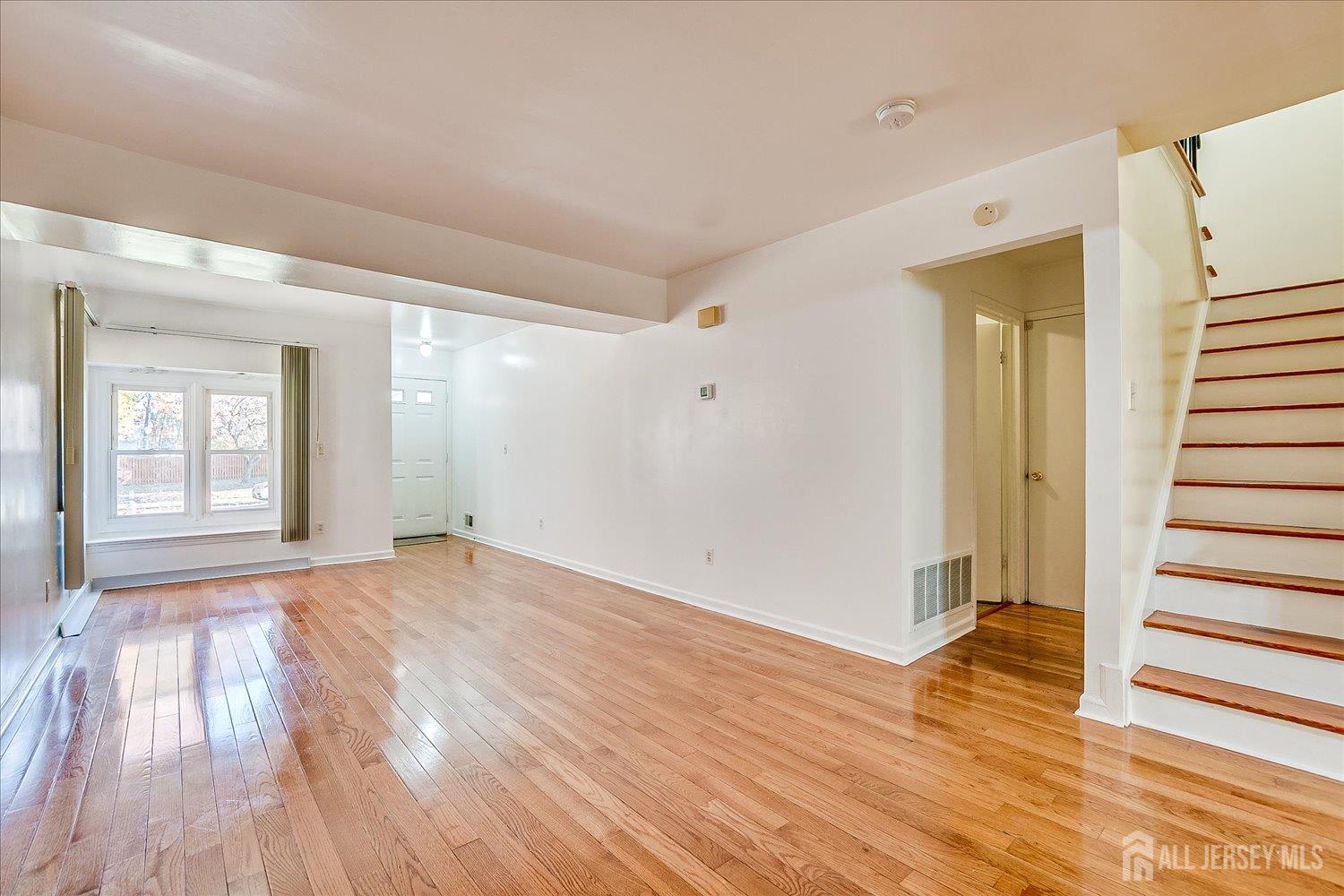 536 Elsie Avenue South Plainfield, NJ 07080 - Photo 4 of 28 a view of an empty room with wooden floor and a window