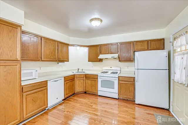 a kitchen with a stove a sink and a refrigerator